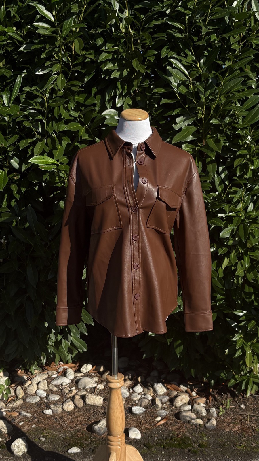 Francesca’s brown leather button up shirt with two breast pockets