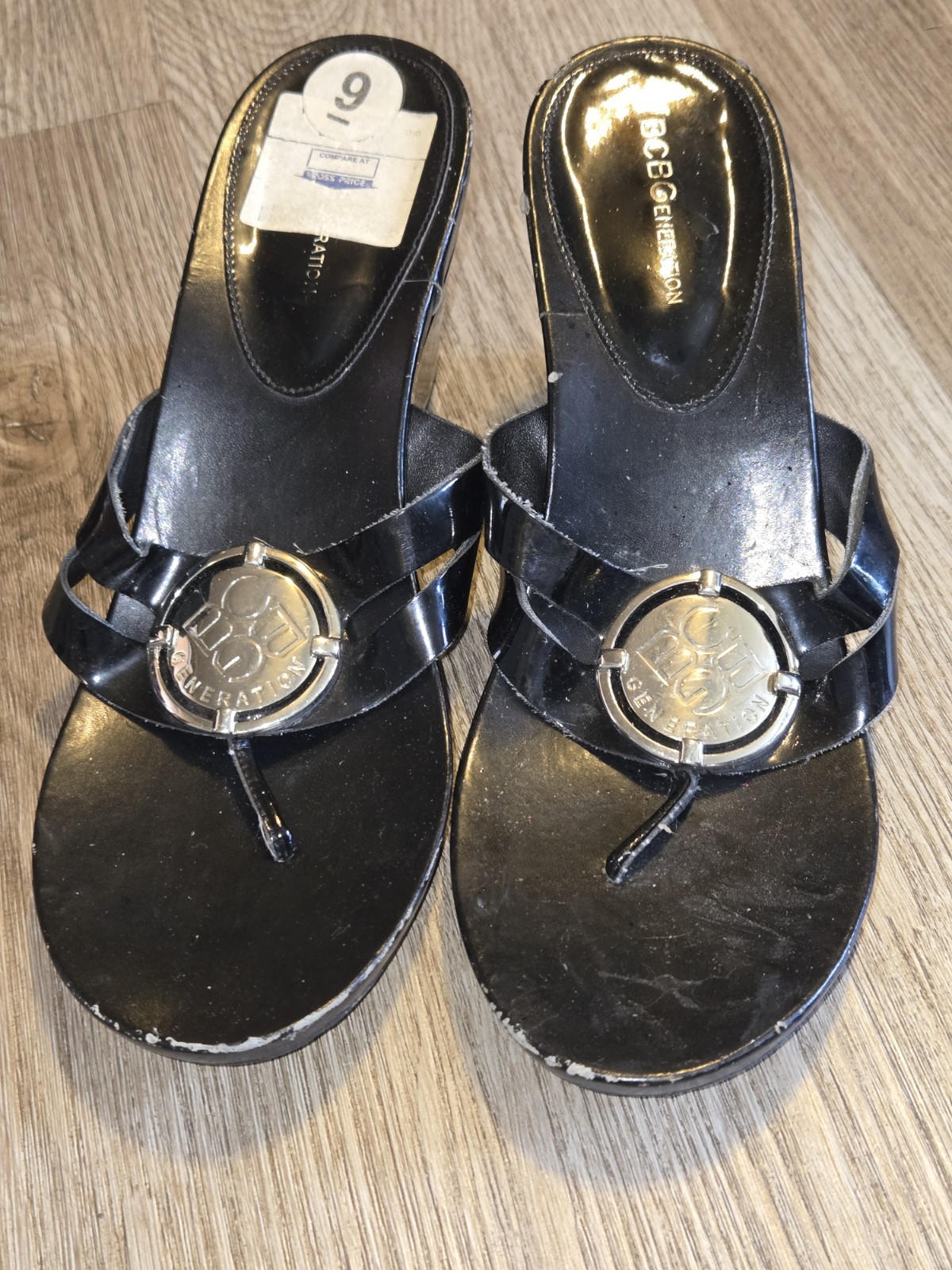 BCBGeneration Black Wedge Thong Sandals Size 9 With Silver Logo Disc