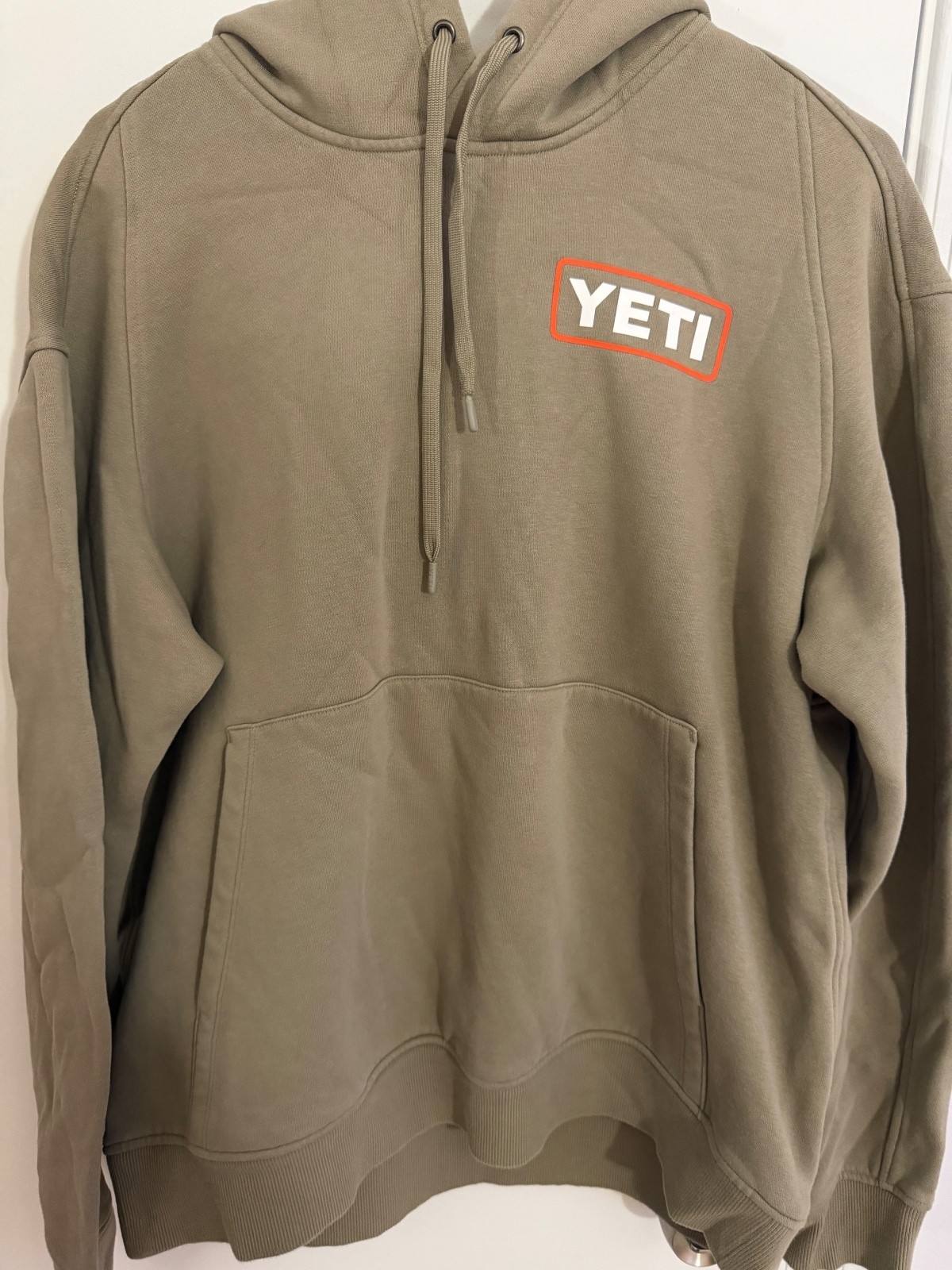 YETI Wetlands Logo Badge Fleece Hoodie in Tan, 75% Cotton 25% Recycled Polyester