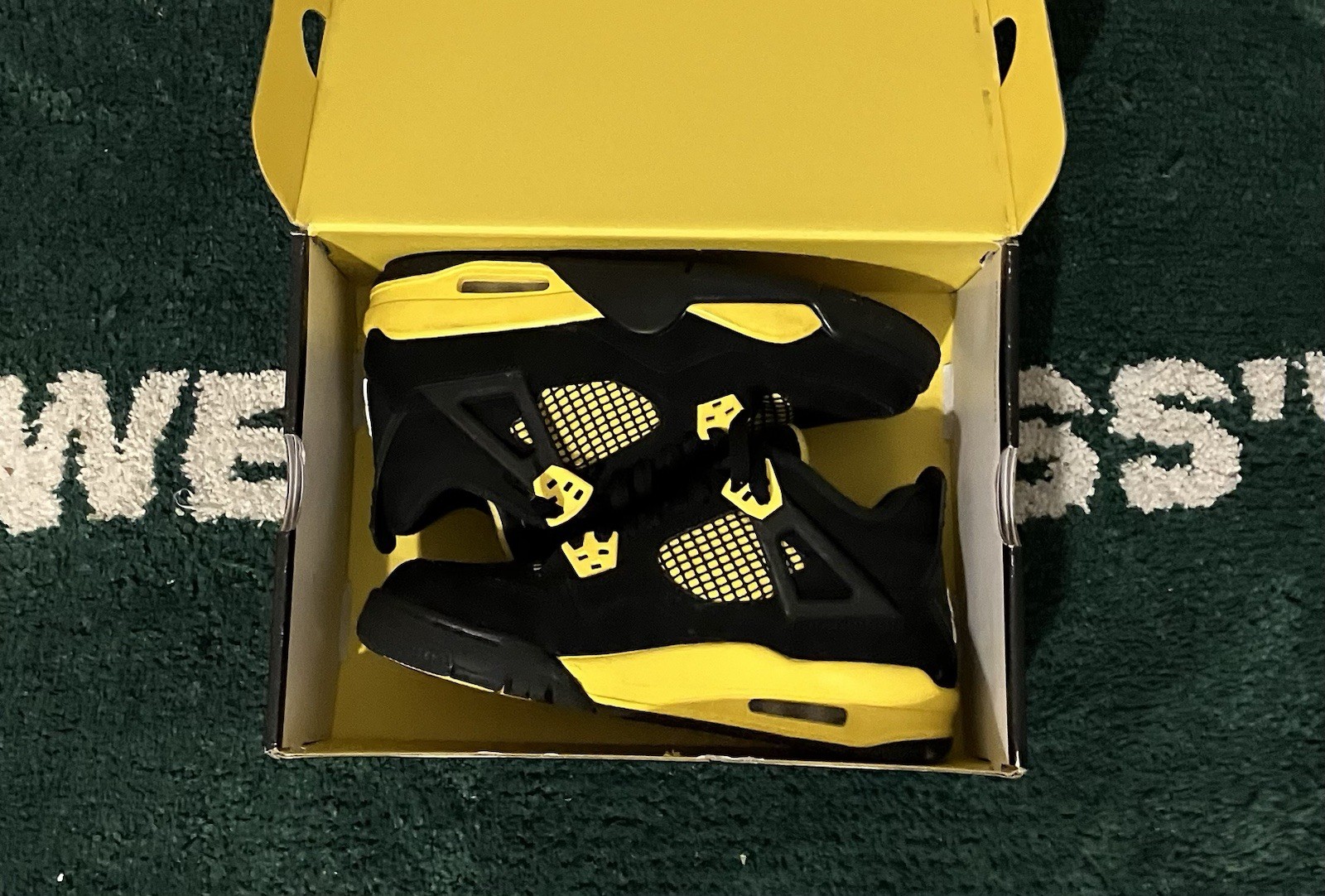 Jordan Air Jordan 4 Black/Yellow thunders Unisex Kids Athletic Lace-Up Sneaker