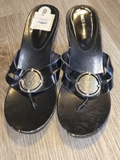 BCBGeneration Black Wedge Thong Sandals Size 9 With Silver Logo Disc picture